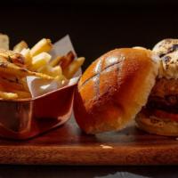 Consulate Burger · 8 oz. burger grilled to perfection, caramelized onions, goats cheese, shredded lettuce, toma...