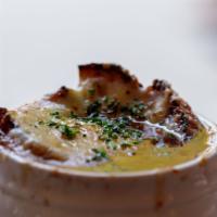 Onion Soup · Classic French onion soup, crisp crouton topped with melted gruyere cheese.
