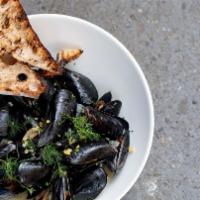 Bowl Of Mussels · Mussels fennel, shallots, garlic, and white wine served with grilled sourdough bread.