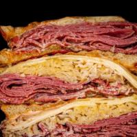 Corned Beef Reuben · Corned Beef • Swiss Cheese • Sauerkraut • Russian • Rye *pressed*