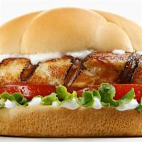 Chicken Sandwich · Delicious Chicken sandwich topped with lettuce, tomato, onion, and chipotle sauce on a brioc...