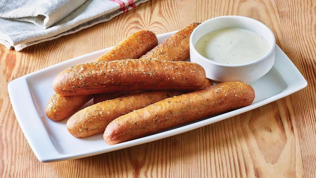 Breadsticks With Alfredo Sauce · Five golden brown signature breadsticks brushed with buttery garlic and parsley. Served with creamy Alfredo sauce for dipping.