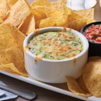 Spinach & Artichoke Dip · Creamy spinach and artichoke dip topped with Parmesan cheese.  Served with freshly made whit...