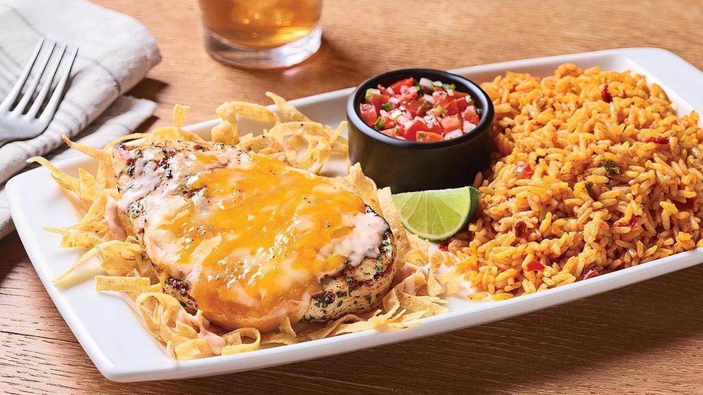 Fiesta Lime Chicken · A celebration of flavor, this dish delivers on every level. Grilled chicken glazed with zesty lime sauce and drizzled with tangy Mexi-ranch is smothered with a rich blend of Cheddar cheeses on a bed of crispy tortilla strips. Served with Spanish rice and house-made pico de gallo.  (Due to supply constraints, salsa may be substituted for pico. Ask your local restaurant for details.)