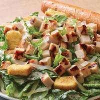 Grilled Chicken Caesar Salad · Crisp romaine tossed in garlic Caesar dressing topped with grilled chicken, croutons and sha...