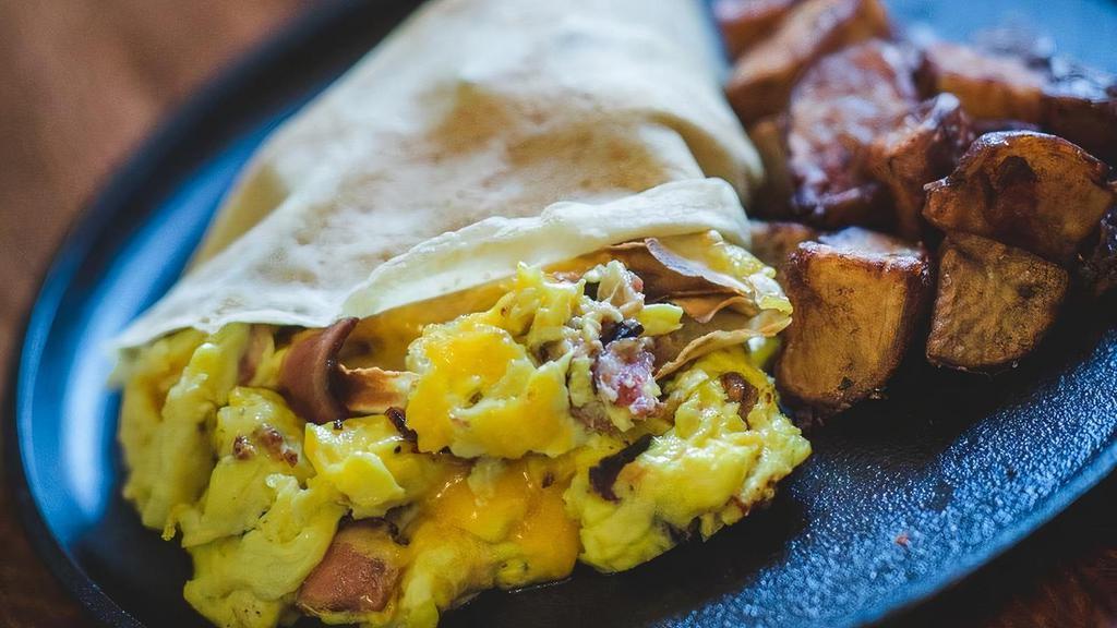 The Breakfast Crepe · Scrambled eggs, cheddar & choice of applewood bacon, Bostrom Farms maple sausage, andouille sausage or smoked ham + crispy red potatoes