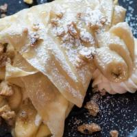 Bananas And Cream Crepe · Fresh banana sauteed in butter and brown sugar, with creme brulee custard, candied walnuts &...