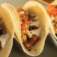Grilled Chicken Tacos · 3 pieces. With sautéed onions, pico de gallo, shredded lettuce, queso fresco.