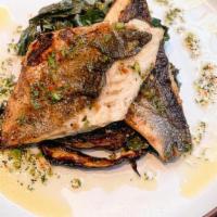 Grilled Branzino · Over roasted cabbage with sauteed swiss chards & herb oil.