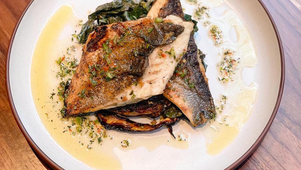 Grilled Branzino · Over roasted cabbage with sauteed swiss chards & herb oil.