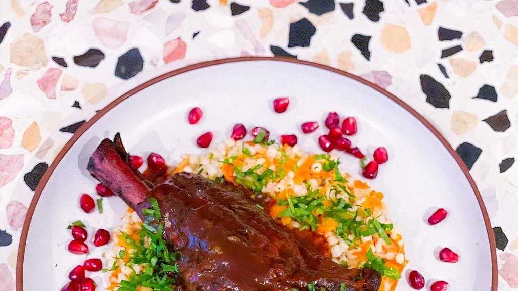 Winter Lamb Oso Bucco · Slow cooked lamb shank with pomegranate molasses, herbed Israeli couscous and braised carrots