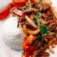 Lomo Saltado · Sautéed beef strips, onions, tomatoes, and cilantro with soy sauce served with white rice an...