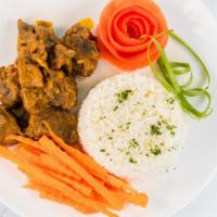 Curry Goat Combo · Served with rice and vegetables.