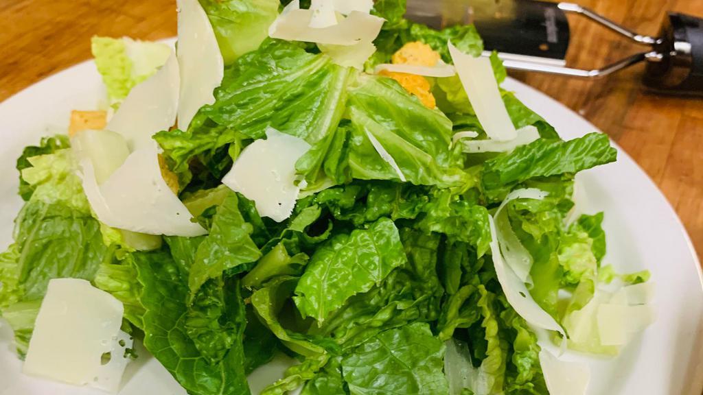 Caesar Salad · Fresh romaine lettuce with homemade croutons and shaved Parmesan cheese.