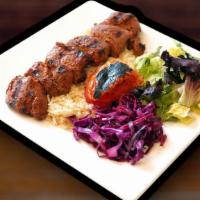 Lamb Shish Kebab · Marinated chunks of lamb grilled to delight on skewers served with rice and salad.