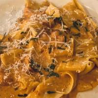 Pappardelle · Tomato cream sauce with double smoked slab bacon.