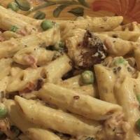 Pasta Vodka · Diced tomatoes and peas in a vodka cream sauce.