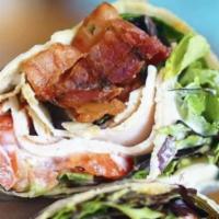 Club Wrap · Mesclun salad, cheese, tomato, turkey, bacon, and ranch wrapped in a warmed flour tortilla.