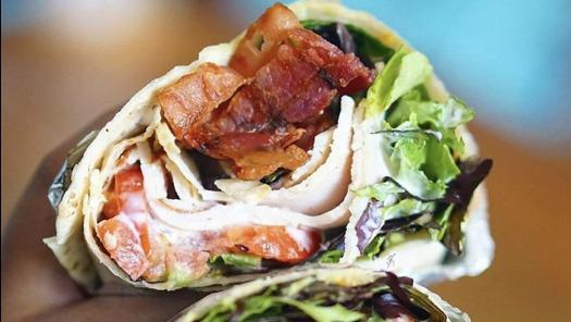 Club Wrap · Mesclun salad, cheese, tomato, turkey, bacon, and ranch wrapped in a warmed flour tortilla.