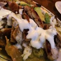Chilaquiles · Vegetarian. Crispy corn tortilla chips covered w/ your choice of salsa verde or roja, topped...