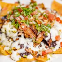 Regular Nachos · Crispy tortilla chips covered w/ refried beans & melted cheese.