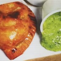 Chicken Empanada · Shredded chicken baked, sauteed with Sofrito sauce and red peppers.