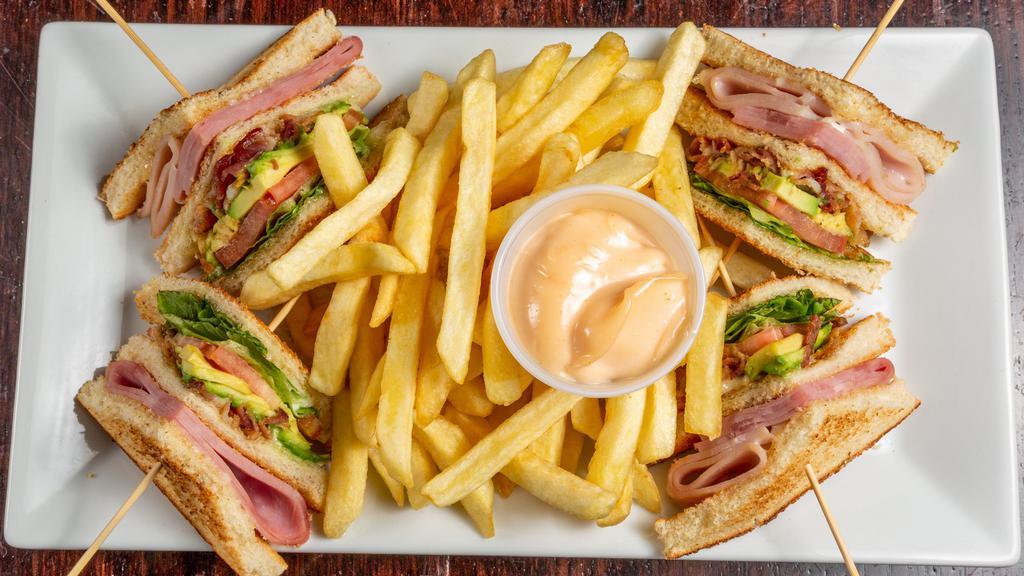 Turkey Club Sandwich · Turkey ham, bacon, avocado, tomato and fries.