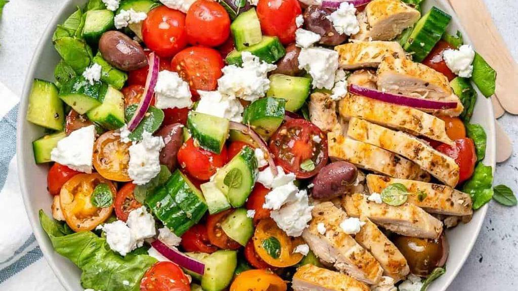 Grilled Chicken Salad · Marinated organic chicken breast over mixed greens, carrots, cucumbers, tomatoes, quinoa, beans, avocado, onions, feta cheese, maple balsamic vinaigrette.