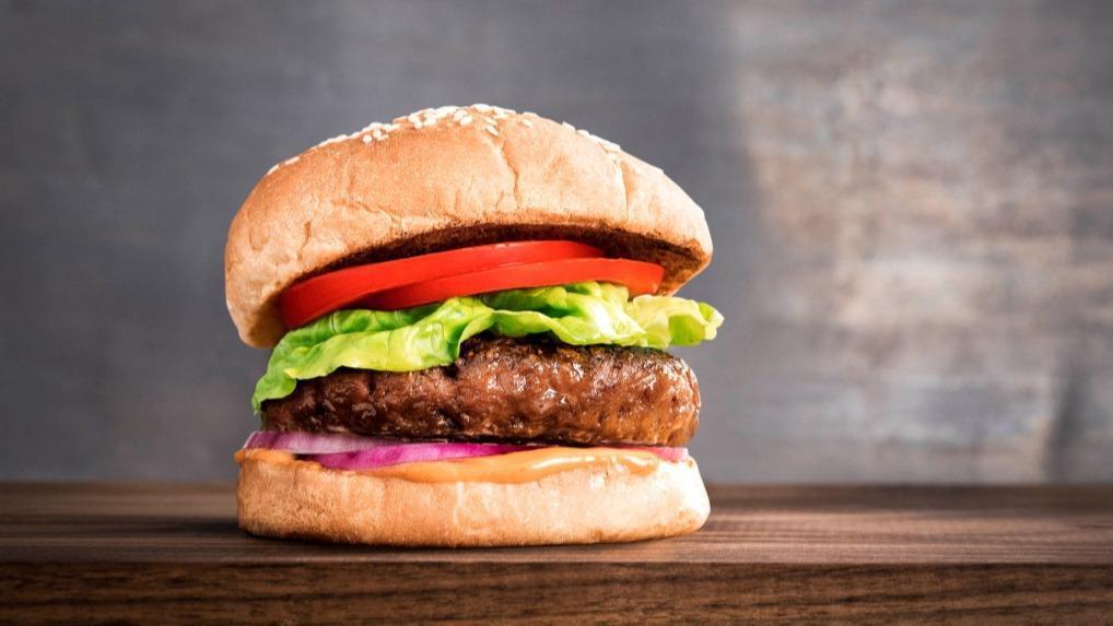 Beyond Impossible Burger · 7 oz. plant-based vegan patty, homemade braised vidalia onions, homemade pesto sauce, homemade pickles, lettuce, tomato.