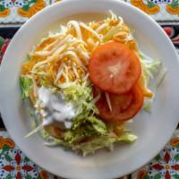 Taco Salad · Chicken or beef with lettuce, black beans, cheese, guacamole, sour cream and tomatoes in a f...