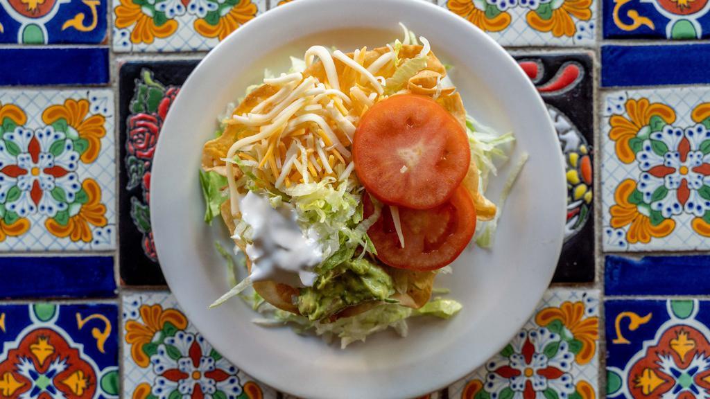 Taco Salad · Chicken or beef with lettuce, black beans, cheese, guacamole, sour cream and tomatoes in a flour tortilla shell.
