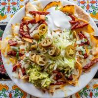 Super Nachos · Nachos topped with guacamole, pico de gallo, sour cream and jalapeños with choice of: Pollo(...