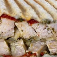 Grilled Chicken Pesto Panini · Grilled Chicken, Melted Mozzarella, Roasted Peppers & Pesto.
