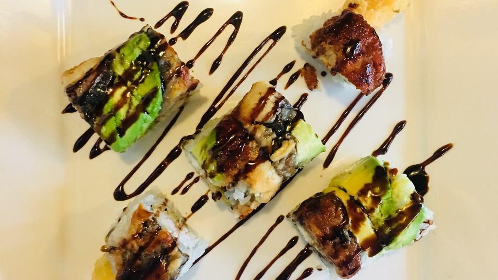 Dragon Roll · Kani and cucumber topped with eel and avocado.