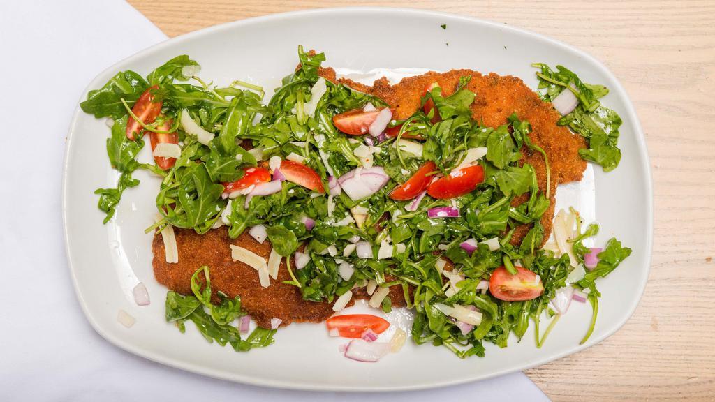 Pork Chop Milanese · 12 oz. Breaded French pork chop topped with baby arugula, red onion, cherry tomatoes, reggiano shavings, and lemon vinaigrette.