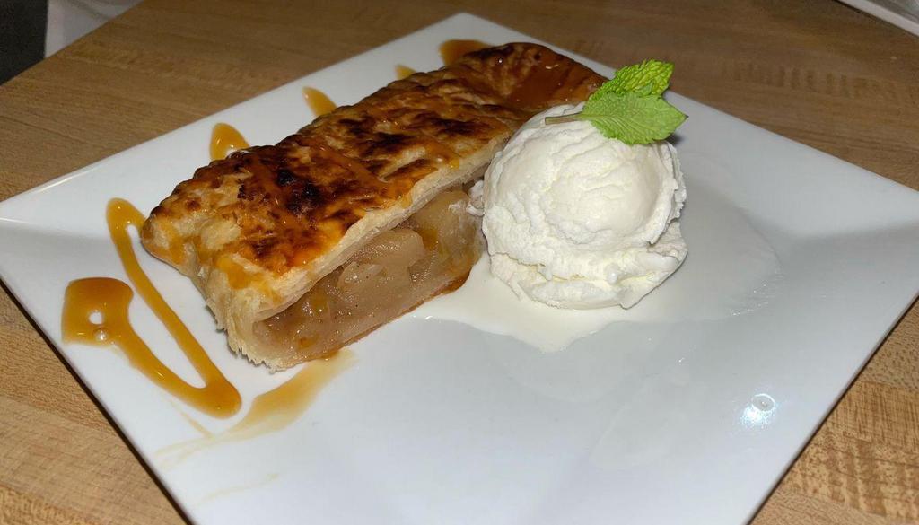 Apple Strudel · Pastry dough, stuffed with fresh apples, and baked, served with a scoop of vanilla ice cream