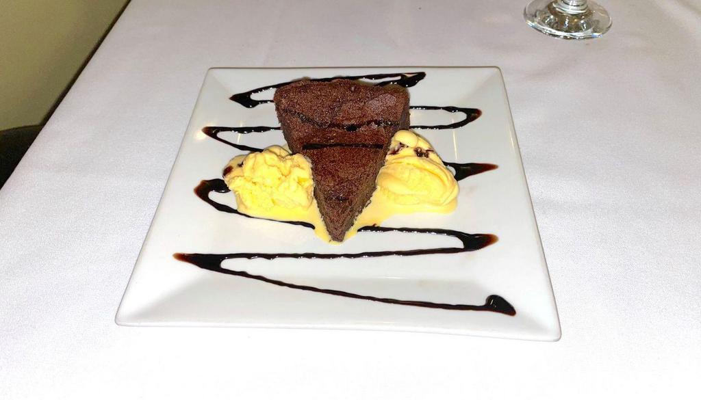 [Gf, V] Flourless Chocolate Cake · Made from Premier Callebaut Semi-Sweet Chocolate, served with a scoop of vanilla ice cream (Gluten-free)