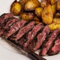 Lombatello · Grilled skirt steak (butcher's steak), thinly sliced and served with roasted potatoes.