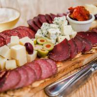 Charcuterie Meat & Cheese Board · An array of smoked meats, cheeses, olives, sun dried tomatoes, and crackers big enough for t...