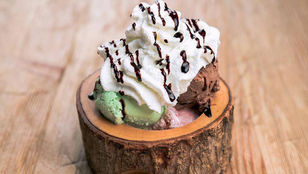 Ice Cream Sundae · Three scoops of your choice of ice cream, topped with whipped cream, chocolate syrup, and a cherry.