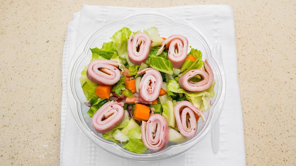 Chefs Salad · Romaine lettuce with ham, turkey and swiss cheese pinwheel tomato, onions, cucumber, and carrots.