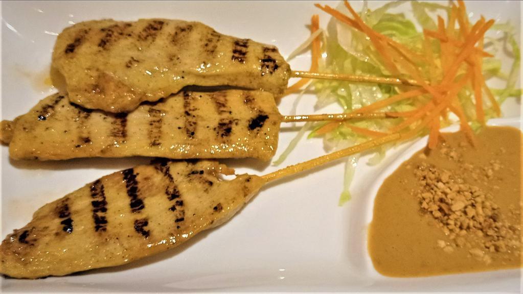 Chicken Satay · Thai style, sliced charcoal-grilled strips of chicken, marinated in lemongrass, and imported Thai curry spice. Served with peanut sauce.