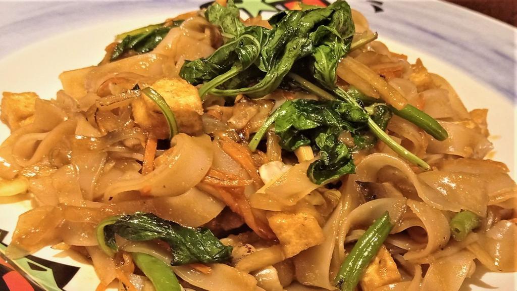 Pad Kee Mow · Thai rice noodle sautéed with fresh vegetables in a sauce made from fresh garlic, chili, basil leaves, and soy sauce.