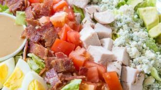 Cobb Salad · Crisp romaine, grilled chicken, bacon bits, boiled egg, tomato and blue cheese.