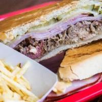 Cubano Sandwich · Mojo-marinated roast pork, virginia ham, Swiss cheese, sour dill pickles and French's yellow...