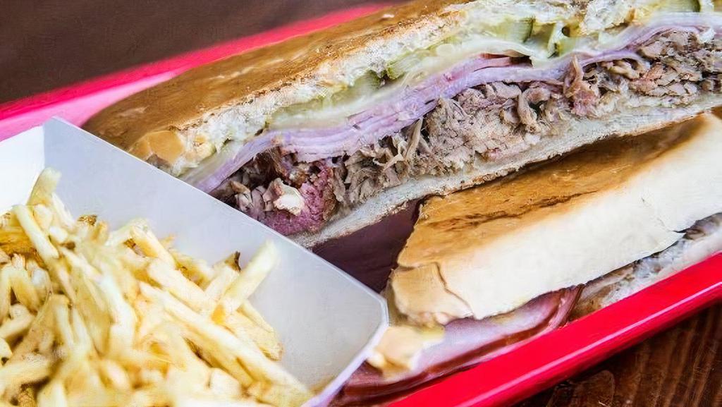 Cubano Sandwich · Mojo-marinated roast pork, virginia ham, Swiss cheese, sour dill pickles and French's yellow mustard on pressed Cuban bread. Served with a side of plantain chips or side salad.