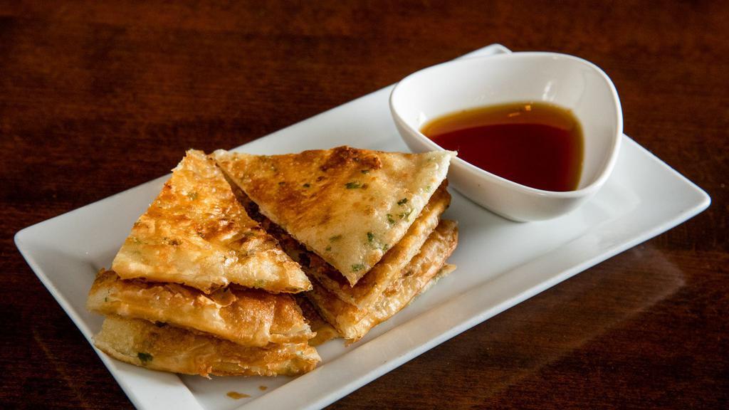 Scallion Pancake · Not Spicy. Scallion pancake cut into eight pieces. Served w/ ginger soy sauce.