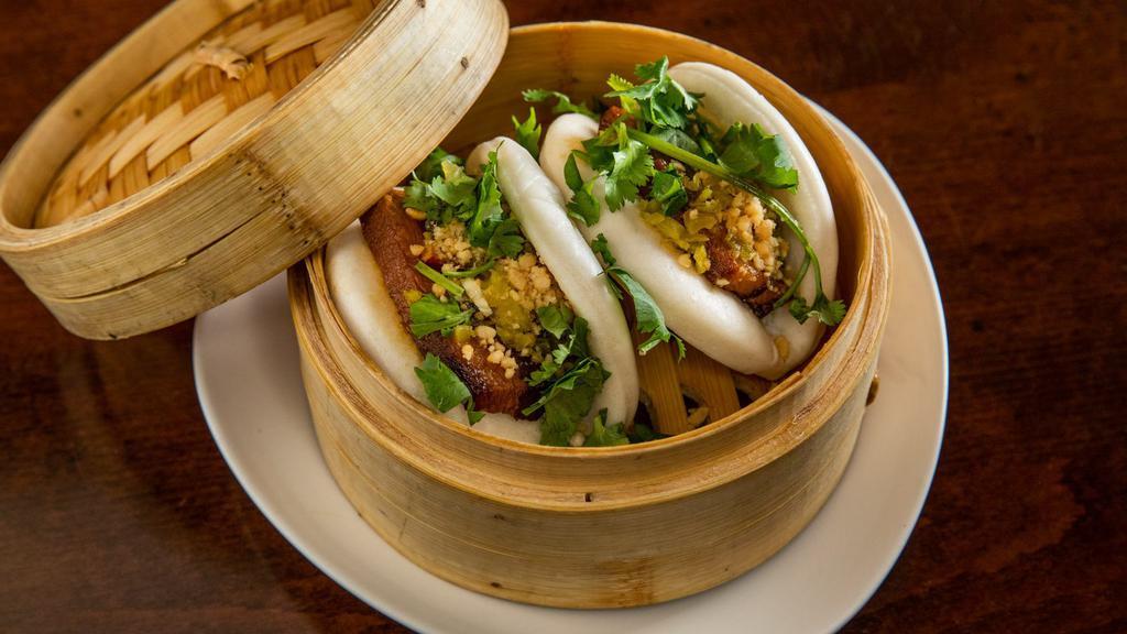 Pork Belly Buns (2Pc) · Not Spicy. Braised pork belly in bao buns topped with cilantro, crushed peanuts and pickled vegetable.