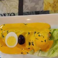 Papa A La Huancaina · Boiled yellow potatoes in mild creamy sauce simply poured over boiled yellow potatoes garnis...