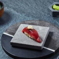 Akami Nigiri · Lean bluefin tuna with daikon dressing and tofu puree. Served with chef's choice of toppings.